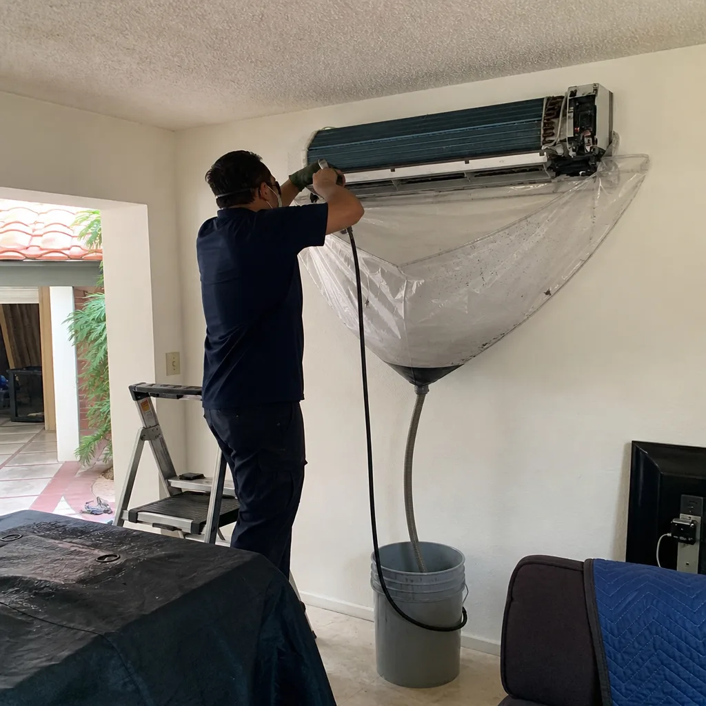 Technician performing professional air conditioner maintenance and deep cleaning service